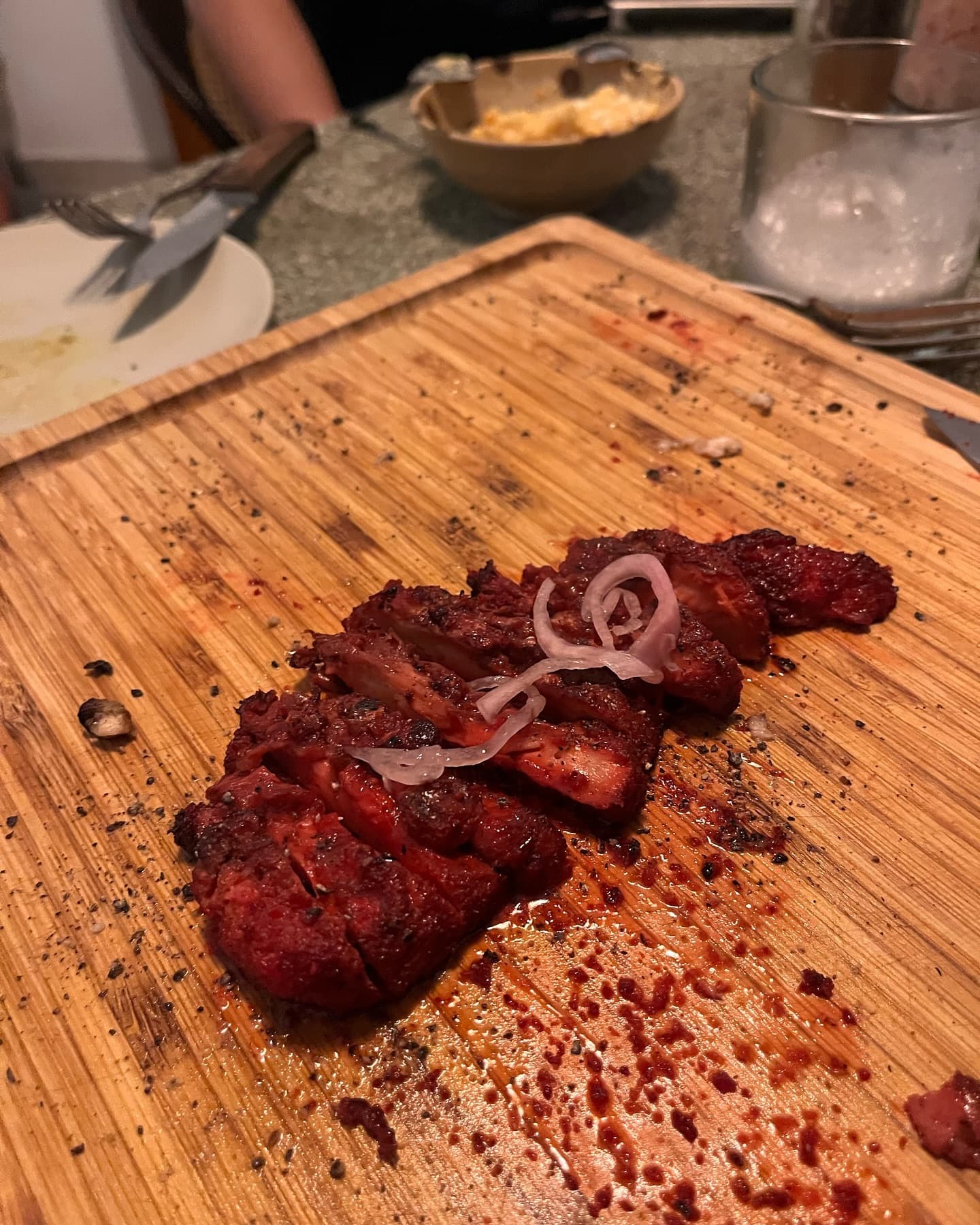 BBQ-glazed Shroomy lion's mane steak, grilled and carved on a board at El Grilla