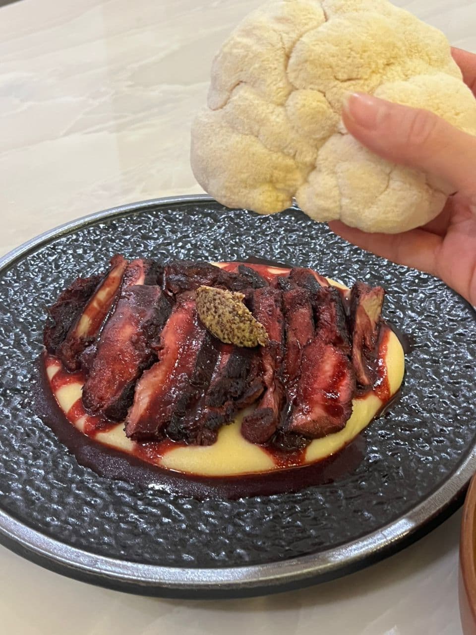 Seared lion's mane plated like steak