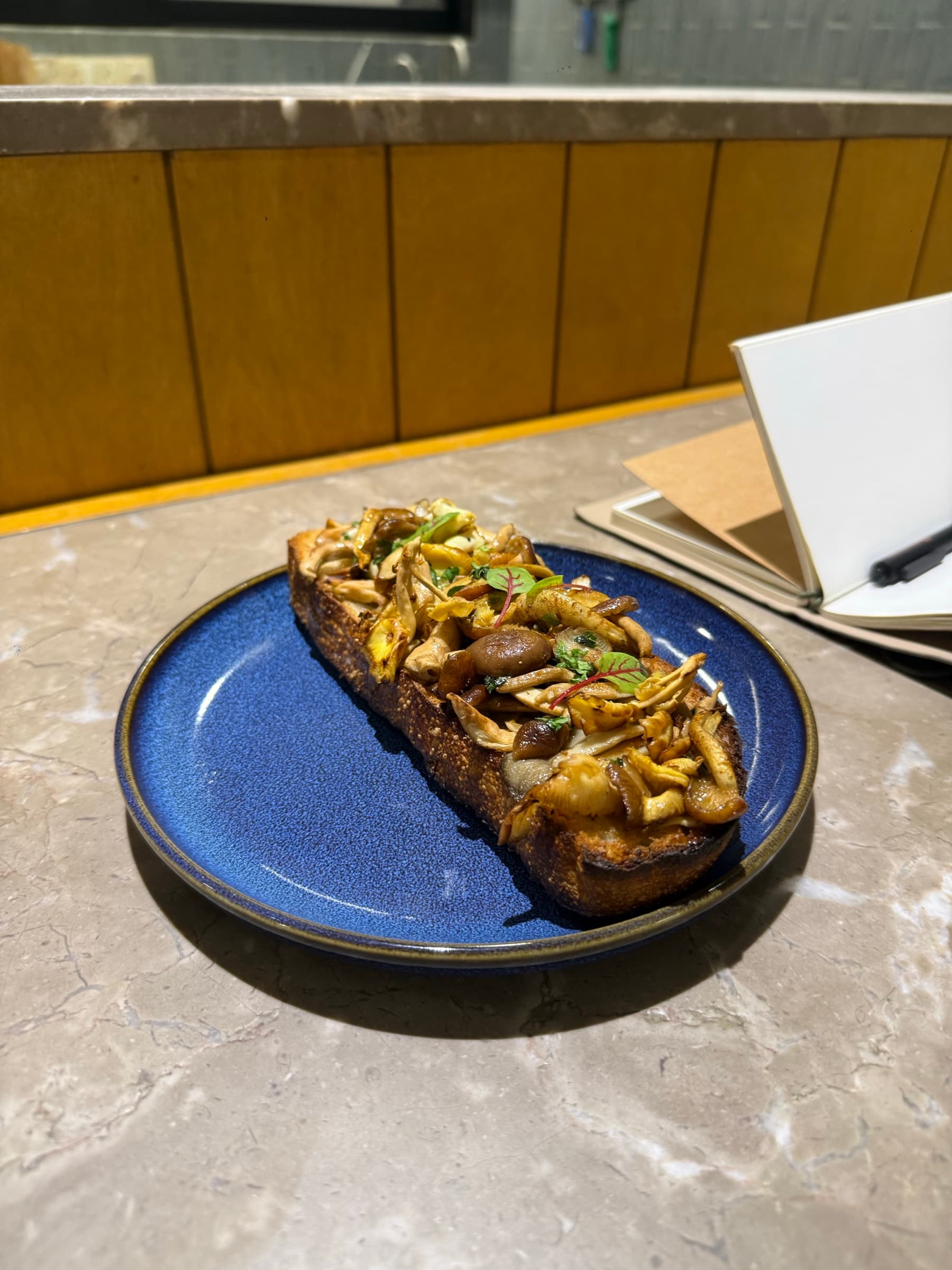 Sautéed mixed mushrooms and microgreens piled on grilled sourdough toast